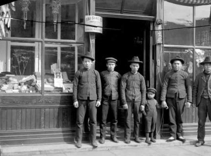 Chinese men and small boy in front of Tai Sing Company