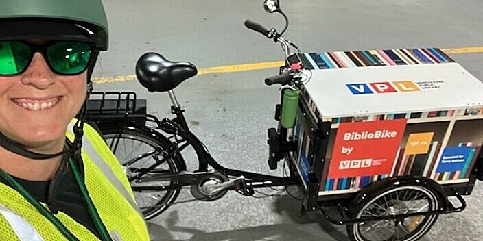 A photograph shows a Vancouver Public Library staff person standing beside the organization's BiblioBike.