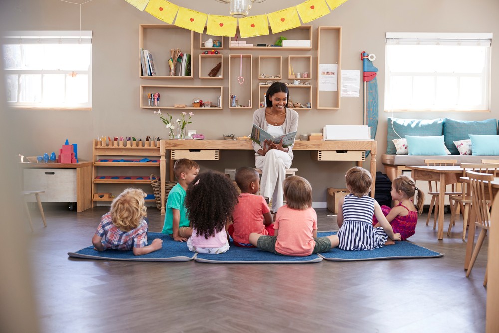 Image of a person reading to a group of small children