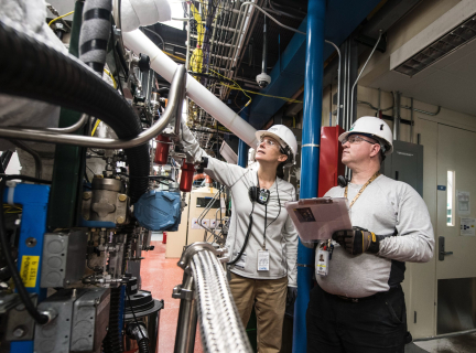 Two engineers inspecting some equipment