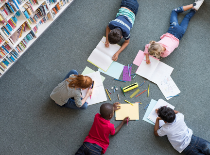 Kids creating books in a library