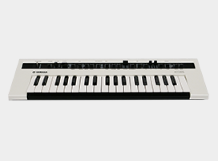 An analog synthesizer with a grey body and several black buttons and dials.