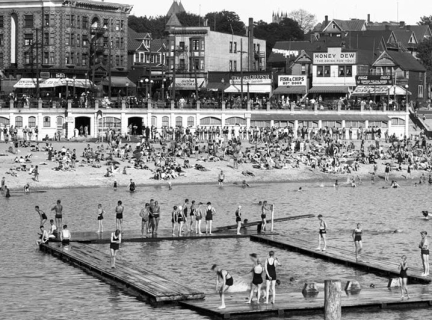 Archival photograph of people swimming and on the beach at English Bay