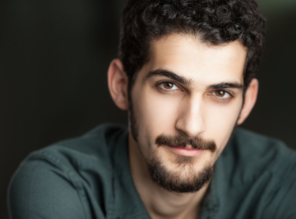 A close-up headshot of artist and writer Francis Dowlatabadi.