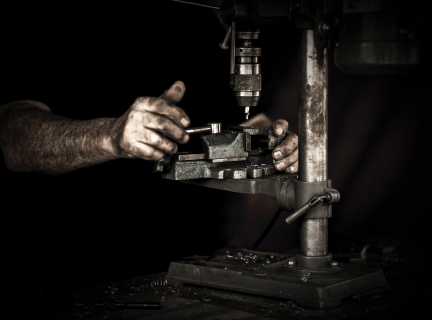 man using drill press