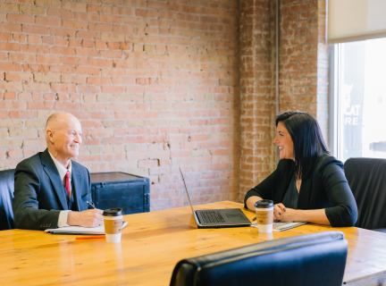 man and woman talking inside office