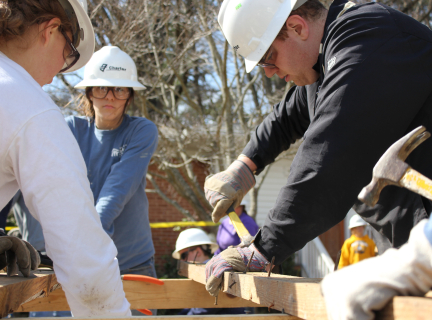 three construction workers working together