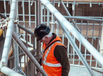 man standing under scaffoldings