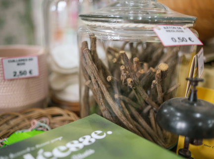 glass container with dried plant matter inside and a price tag on the outside