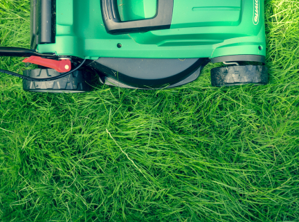 green and black lawnmower on green grass