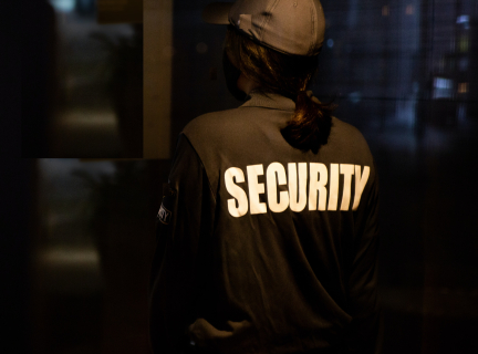 person wearing a jacket with the word security on it