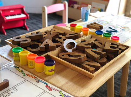 brown wooden toy letters on a table for children