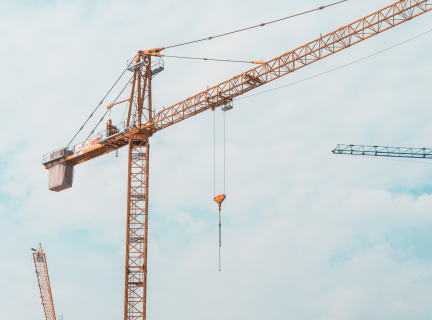 a yellow crane in a construction site