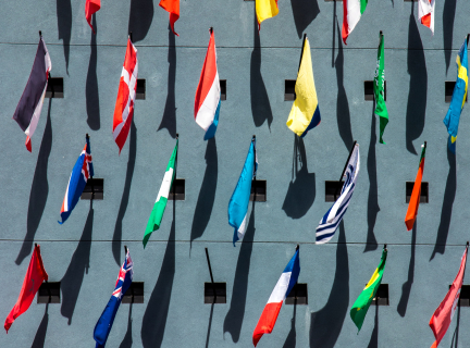 photo of assorted-color nation flags on wall during daytime