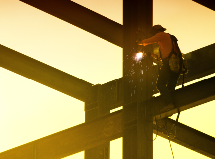 iron worker welding steel beam