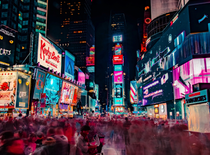 time-lapse photography of crowd of people on New York Time square during night time