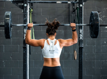 A photograph of a weighlifter working out in a gym. 