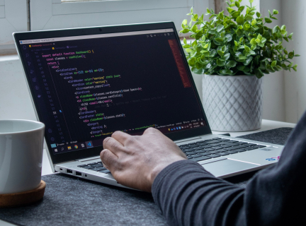 person doing web development work on a laptop