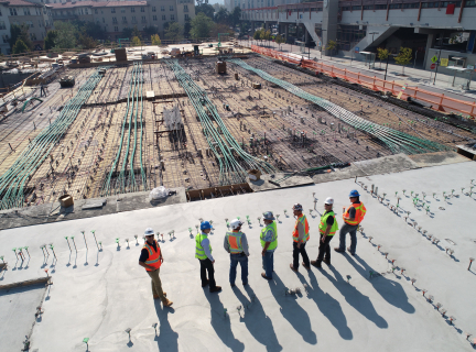 seven construction workers standing on construction site