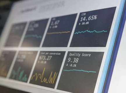 computer monitor showing financial graphs