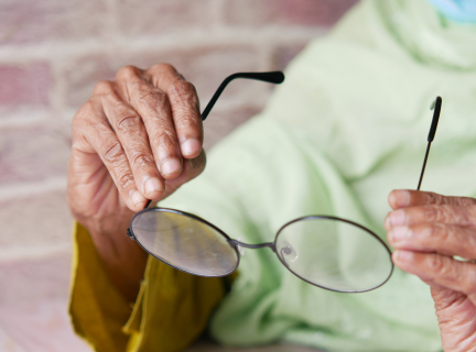 person holding a pair of glasses