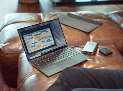 black and gray laptop computer on brown leather couch