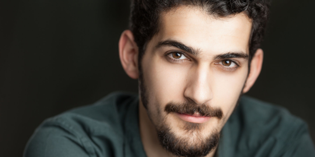 A close-up headshot of artist and writer Francis Dowlatabadi.