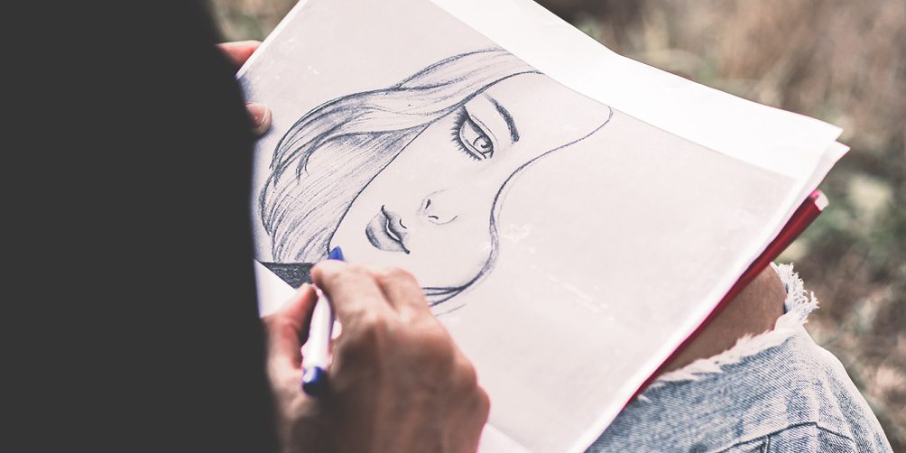 Teen sketching woman's face