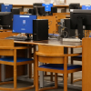 Several bublic computer workstations on desks in the Vancouver Public Library.